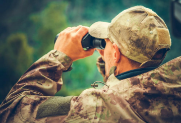 Man in cameo looking through binoculars.