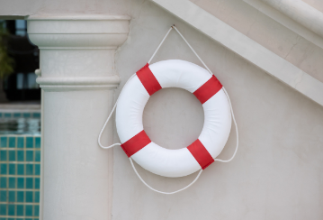 A lifesaver flotation device hangs on a wall.