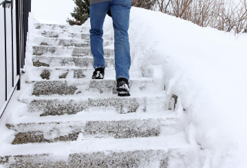 Person walking up snowy steps.